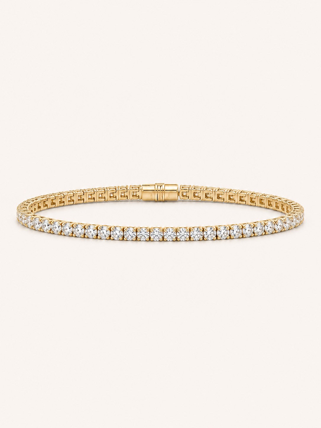 A 14K gold lab-grown diamond tennis bracelet on a soft beige backdrop