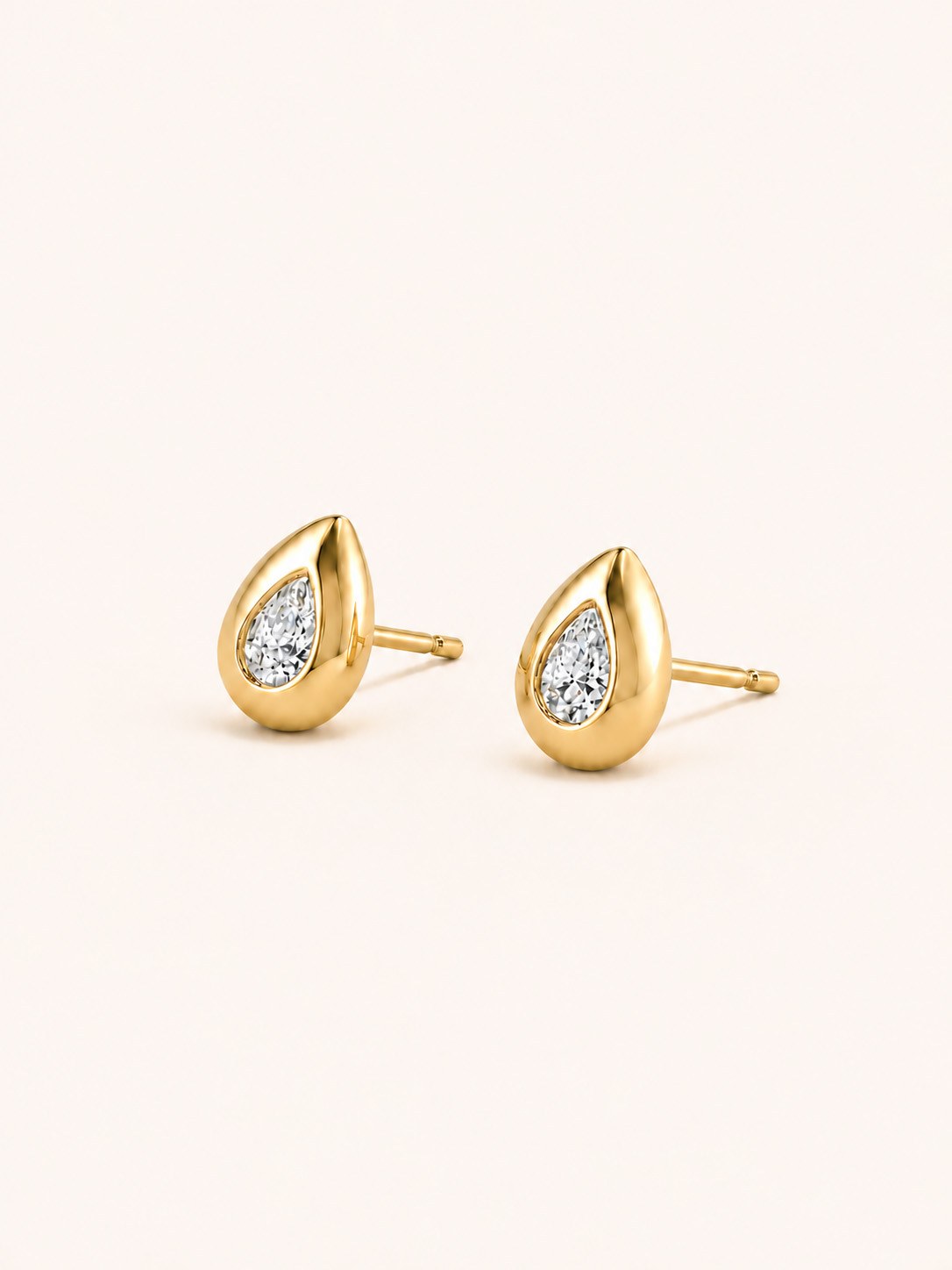 A pair of pear brilliant-cut gold solitaire stud earrings