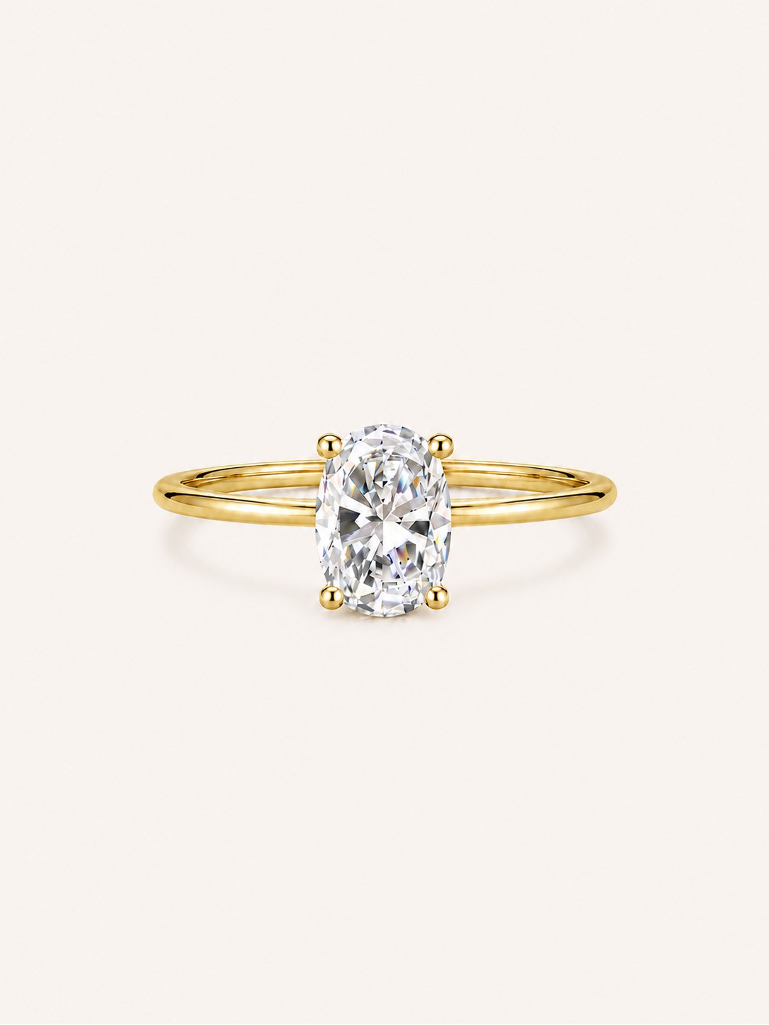 An oval-cut lab-grown diamond solitaire ring in 14K gold
